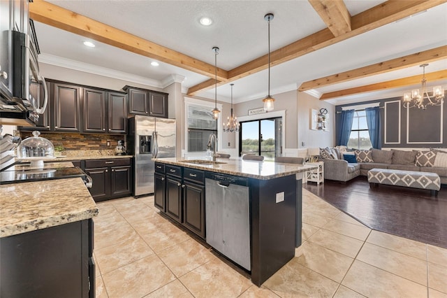 1604 Acadia Harbor Pl, Brandon, FL 33511 - kitchen featuring stainless steel appliances, a chandelier, beamed ceiling, decorative backsplash, and open floor plan