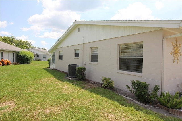 402 Dorchester Pl Unit 44, Sun City Center, FL 33573 - view of home's exterior with a lawn and concrete block siding