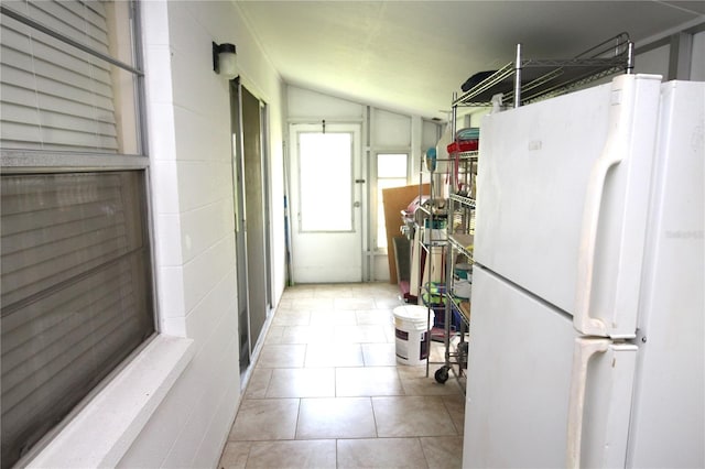 402 Dorchester Pl Unit 44, Sun City Center, FL 33573 - kitchen featuring freestanding refrigerator, lofted ceiling, and tile patterned flooring