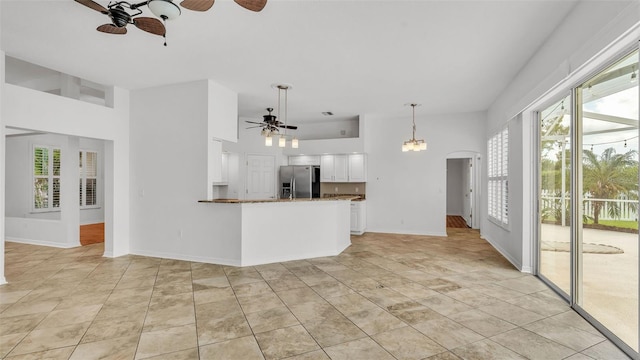 2202 Hickory Ridge Dr, Valrico, FL 33596 - unfurnished living room with a ceiling fan, arched walkways, and a towering ceiling