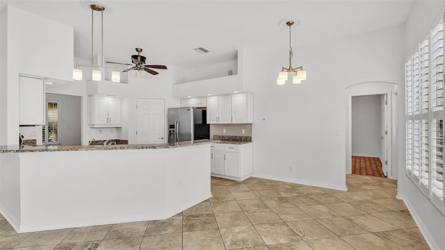 2202 Hickory Ridge Dr, Valrico, FL 33596 - kitchen featuring stainless steel fridge with ice dispenser, a ceiling fan, stone counters, a high ceiling, and white cabinets