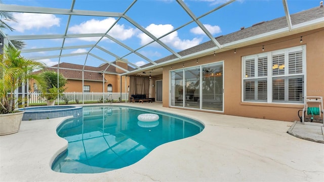 2202 Hickory Ridge Dr, Valrico, FL 33596 - view of swimming pool featuring a patio area, glass enclosure, and a pool with connected hot tub
