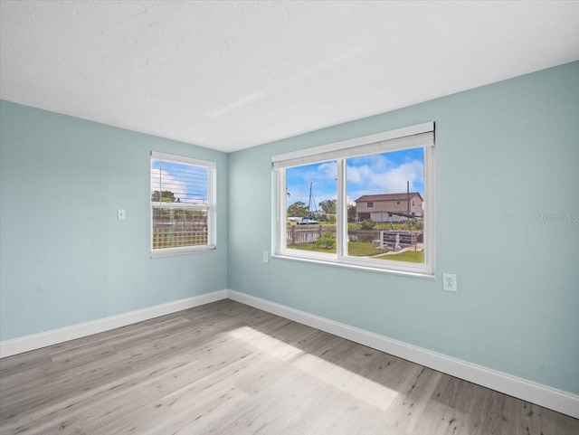 13316 Carol Dr, Hudson, FL 34667 - empty room featuring wood finished floors and baseboards