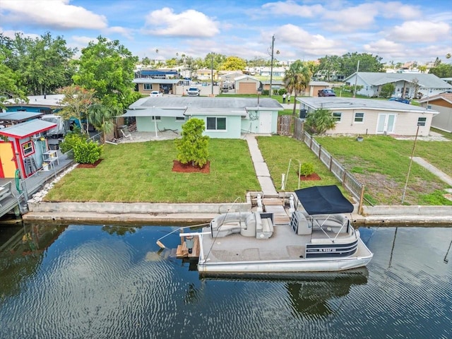 13316 Carol Dr, Hudson, FL 34667 - rear view of house with a water view, a fenced backyard, and a residential view