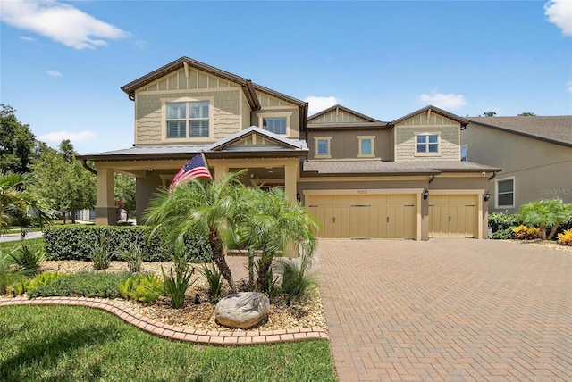 10313 Scarlet Chase Dr, Riverview, FL 33569 - craftsman-style home featuring an attached garage, decorative driveway, and stucco siding