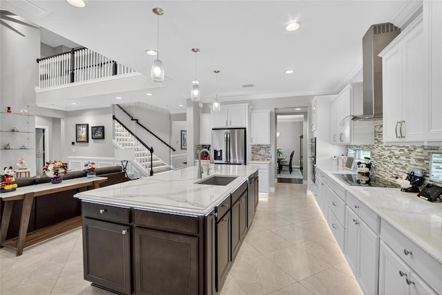 10313 Scarlet Chase Dr, Riverview, FL 33569 - kitchen with stainless steel appliances, wall chimney exhaust hood, light tile patterned floors, white cabinets, and recessed lighting
