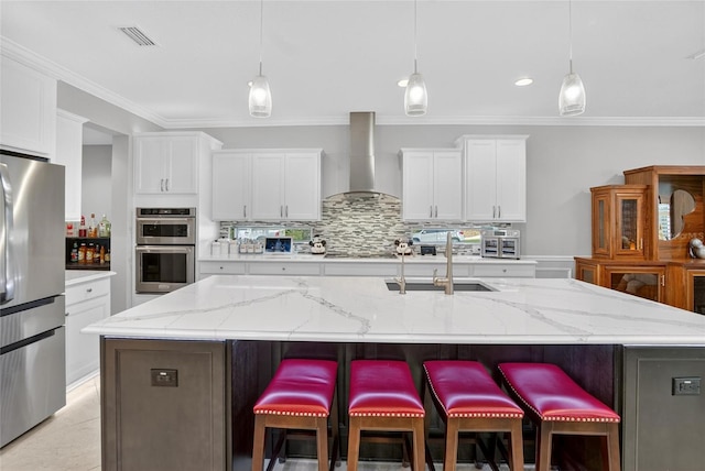 10313 Scarlet Chase Dr, Riverview, FL 33569 - kitchen with wall chimney exhaust hood, stainless steel appliances, crown molding, decorative backsplash, and white cabinetry