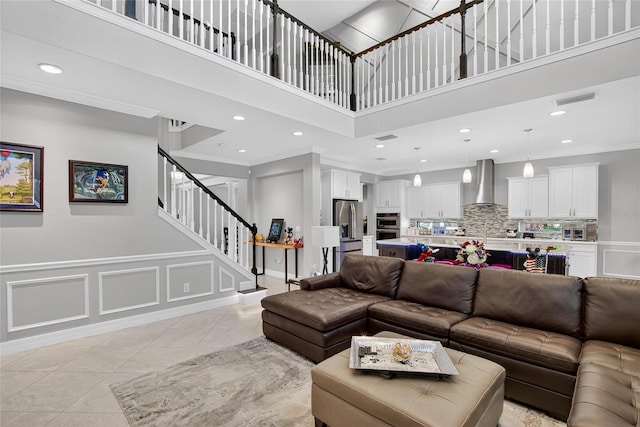10313 Scarlet Chase Dr, Riverview, FL 33569 - living room featuring a high ceiling, stairway, recessed lighting, ornamental molding, and light tile patterned floors