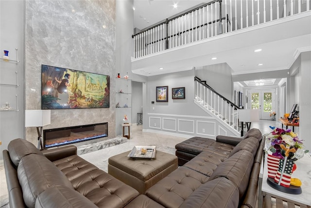 10313 Scarlet Chase Dr, Riverview, FL 33569 - living room with a towering ceiling, stairway, ornamental molding, a fireplace, and a decorative wall