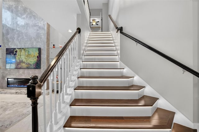 10313 Scarlet Chase Dr, Riverview, FL 33569 - stairs with a large fireplace and ceiling fan