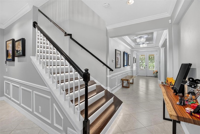 10313 Scarlet Chase Dr, Riverview, FL 33569 - stairs featuring tile patterned flooring, crown molding, a decorative wall, a wainscoted wall, and a chandelier