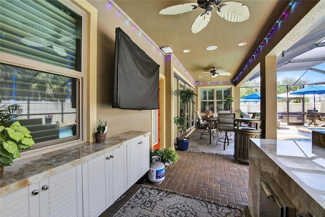 10313 Scarlet Chase Dr, Riverview, FL 33569 - view of patio featuring a ceiling fan, outdoor dining space, a lanai, and exterior kitchen