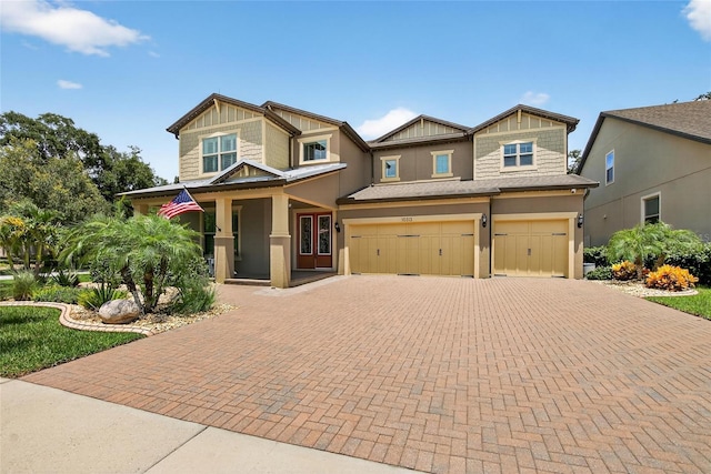10313 Scarlet Chase Dr, Riverview, FL 33569 - craftsman house featuring an attached garage, decorative driveway, covered porch, and stucco siding