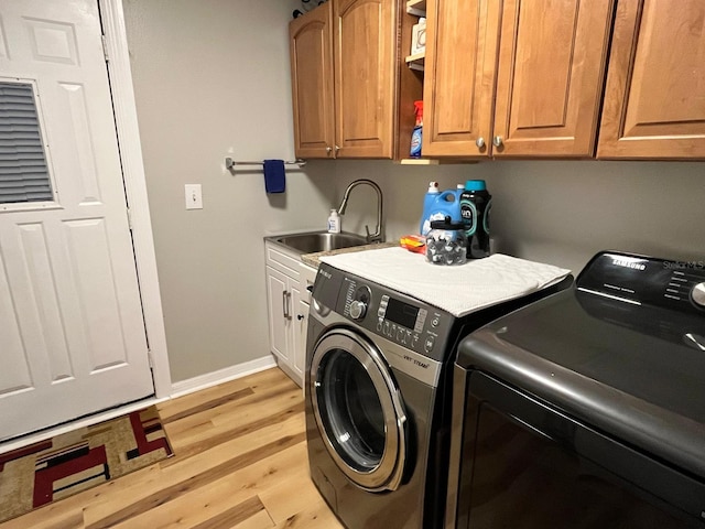 8616 Pinafore Dr, New Port Richey, FL 34653 - laundry area with cabinet space, independent washer and dryer, and light wood finished floors