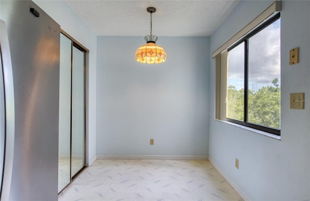 700 Starkey Rd Unit 1145, Largo, FL 33771 - unfurnished dining area featuring a textured ceiling and baseboards