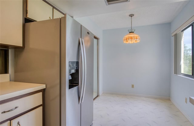 700 Starkey Rd Unit 1145, Largo, FL 33771 - kitchen with stainless steel refrigerator with ice dispenser, light countertops, plenty of natural light, and hanging light fixtures