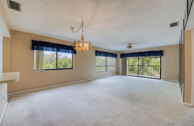 700 Starkey Rd Unit 1145, Largo, FL 33771 - empty room with a chandelier, carpet floors, ceiling fan, and a textured ceiling