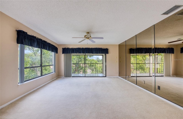 700 Starkey Rd Unit 1145, Largo, FL 33771 - carpeted spare room with ceiling fan, a textured ceiling, and plenty of natural light