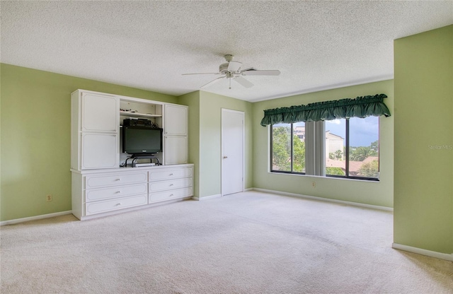 700 Starkey Rd Unit 1145, Largo, FL 33771 - unfurnished bedroom featuring light colored carpet, a ceiling fan, and a textured ceiling