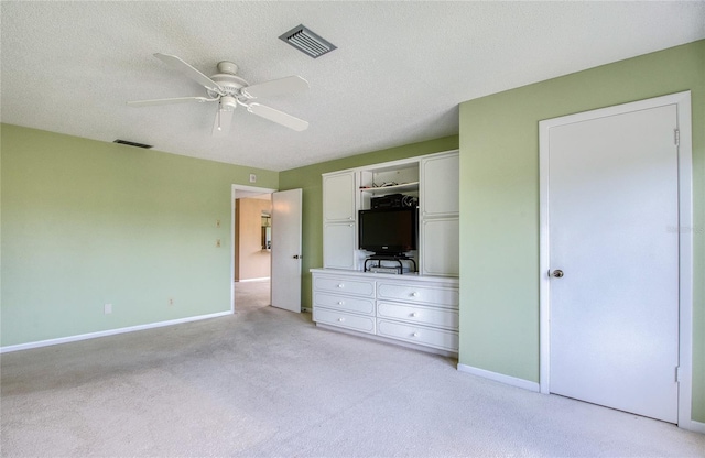 700 Starkey Rd Unit 1145, Largo, FL 33771 - unfurnished bedroom featuring light colored carpet, a ceiling fan, and a textured ceiling