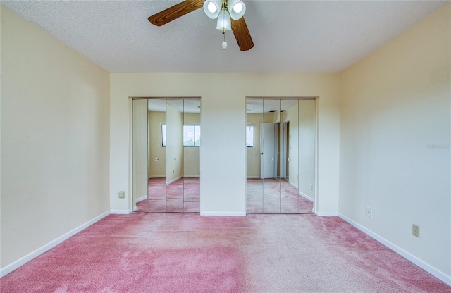 700 Starkey Rd Unit 1145, Largo, FL 33771 - unfurnished bedroom featuring two closets, carpet floors, and ceiling fan