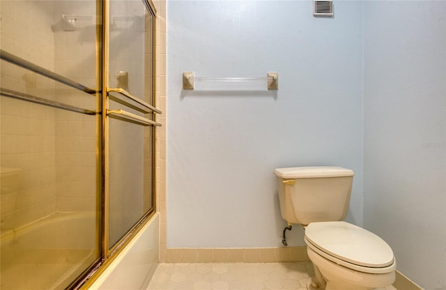 700 Starkey Rd Unit 1145, Largo, FL 33771 - bathroom featuring shower / bath combination with glass door and tile patterned flooring