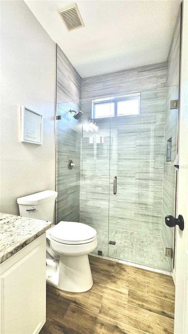 27312 Edenfield Dr, Wesley Chapel, FL 33544 - full bath featuring vanity, wood finished floors, and a shower stall