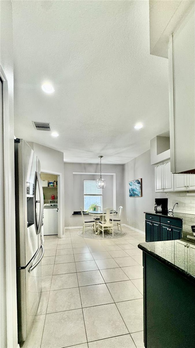 27312 Edenfield Dr, Wesley Chapel, FL 33544 - kitchen with stainless steel fridge, light tile patterned flooring, recessed lighting, decorative backsplash, and white cabinetry