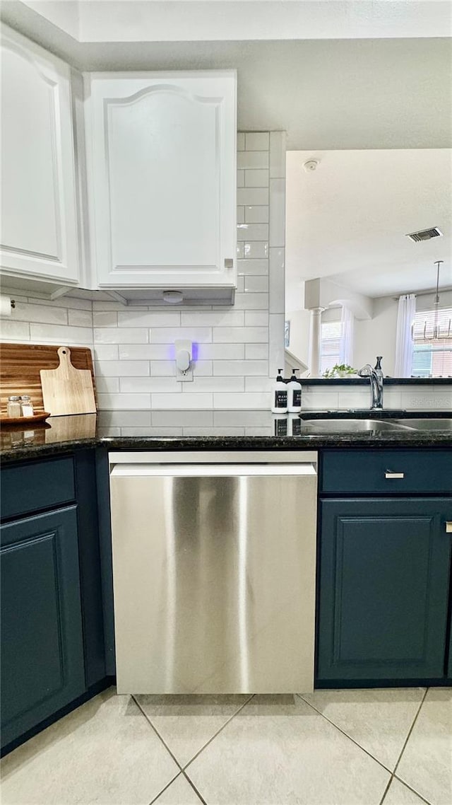 27312 Edenfield Dr, Wesley Chapel, FL 33544 - kitchen featuring stainless steel dishwasher, light tile patterned floors, white cabinetry, and tasteful backsplash