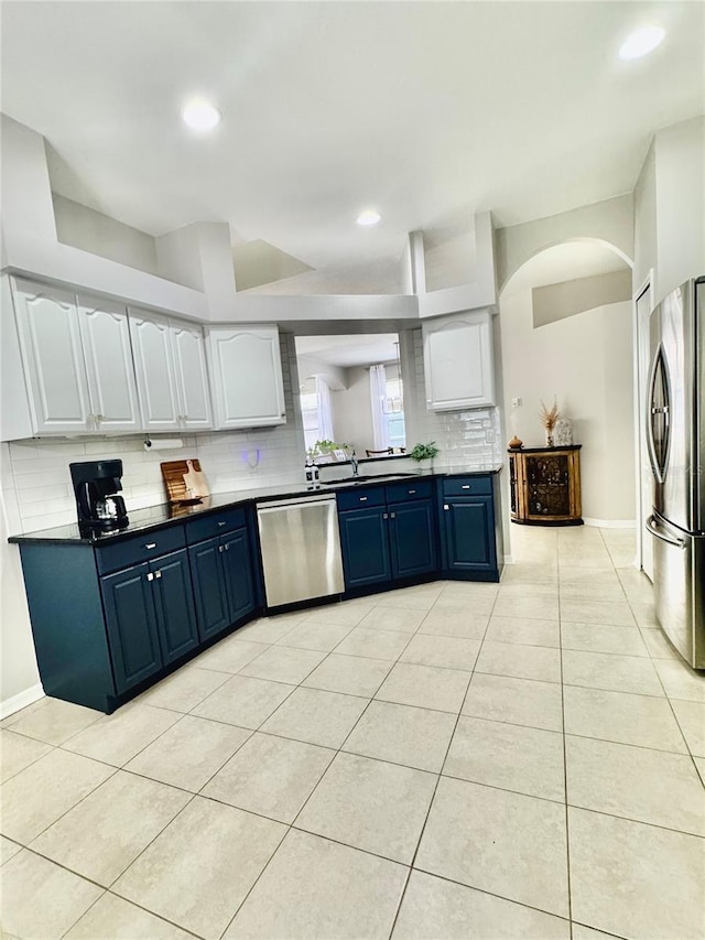 27312 Edenfield Dr, Wesley Chapel, FL 33544 - kitchen featuring appliances with stainless steel finishes, blue cabinets, backsplash, light tile patterned floors, and recessed lighting