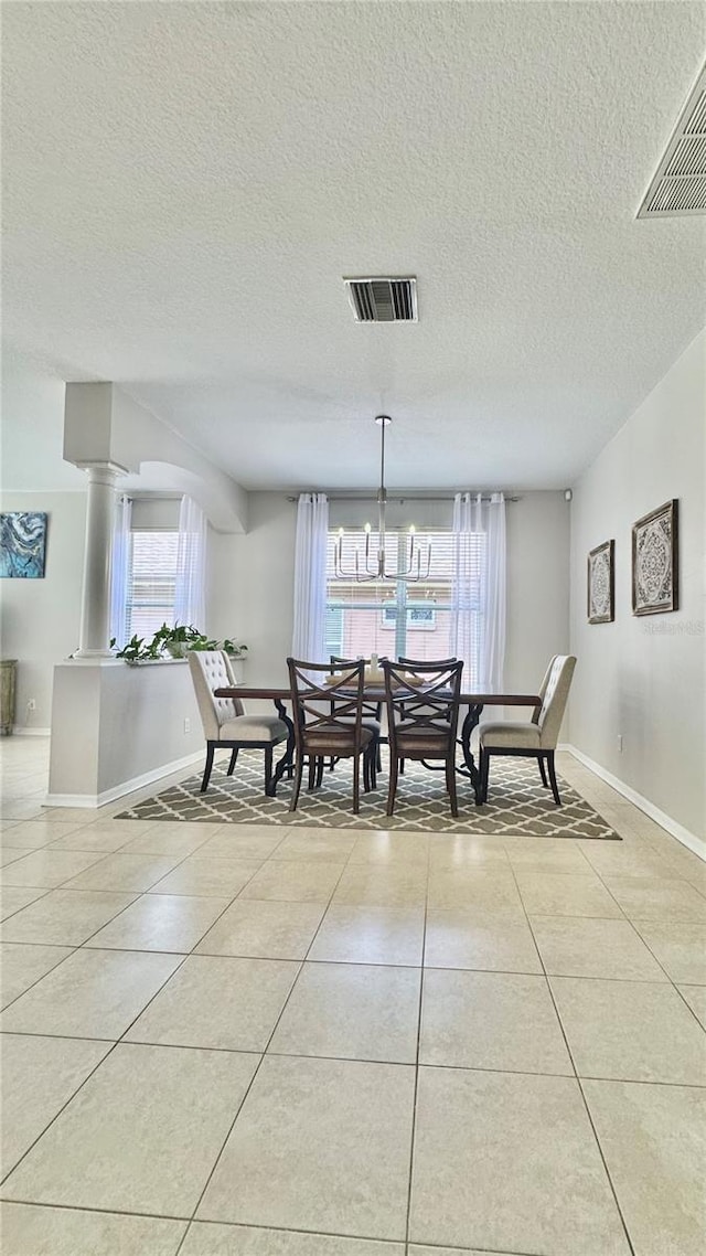 27312 Edenfield Dr, Wesley Chapel, FL 33544 - dining space featuring light tile patterned floors and a textured ceiling