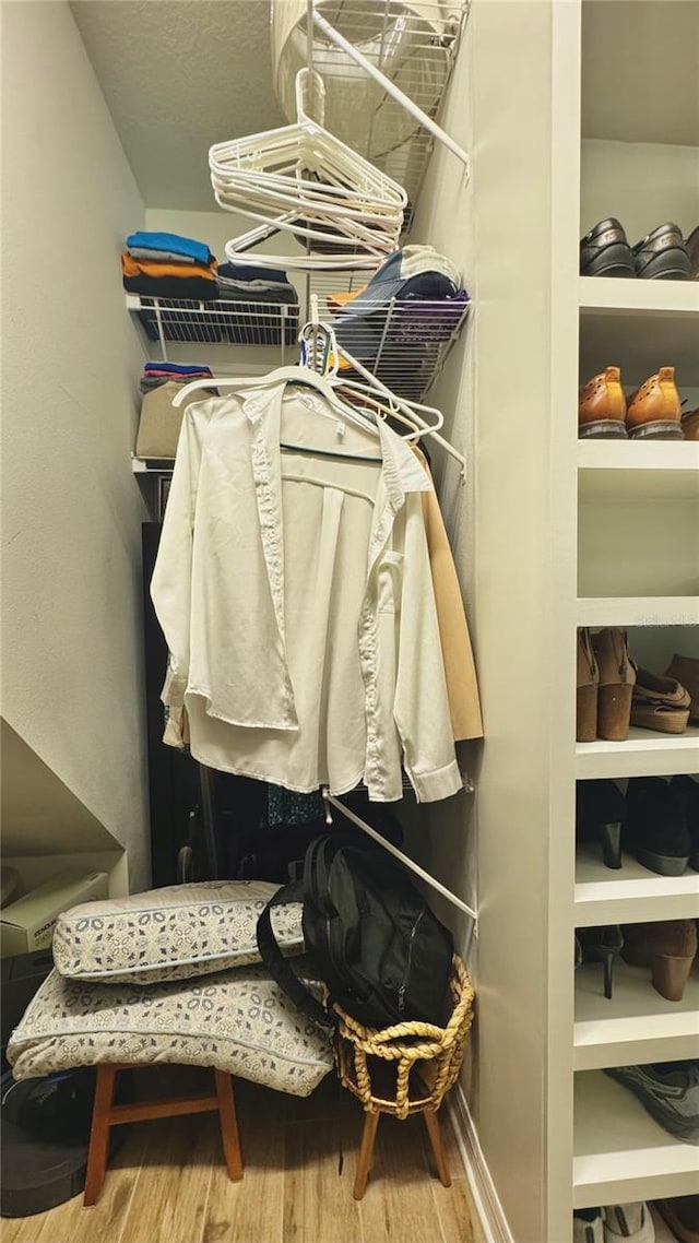 27312 Edenfield Dr, Wesley Chapel, FL 33544 - walk in closet featuring wood finished floors