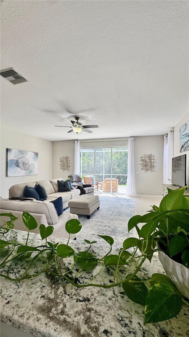 27312 Edenfield Dr, Wesley Chapel, FL 33544 - living area with a textured ceiling and a ceiling fan