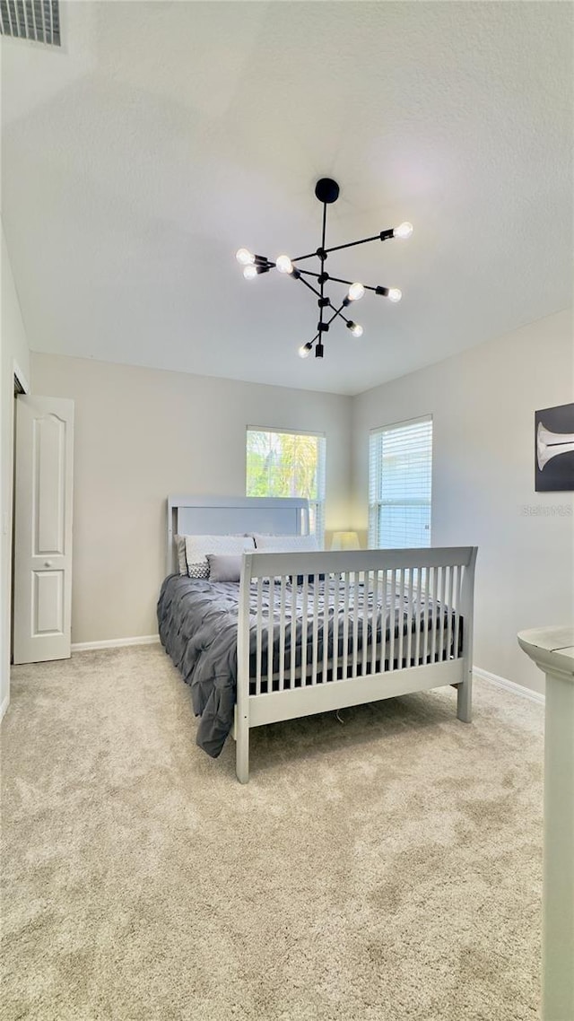 27312 Edenfield Dr, Wesley Chapel, FL 33544 - bedroom with carpet and a chandelier