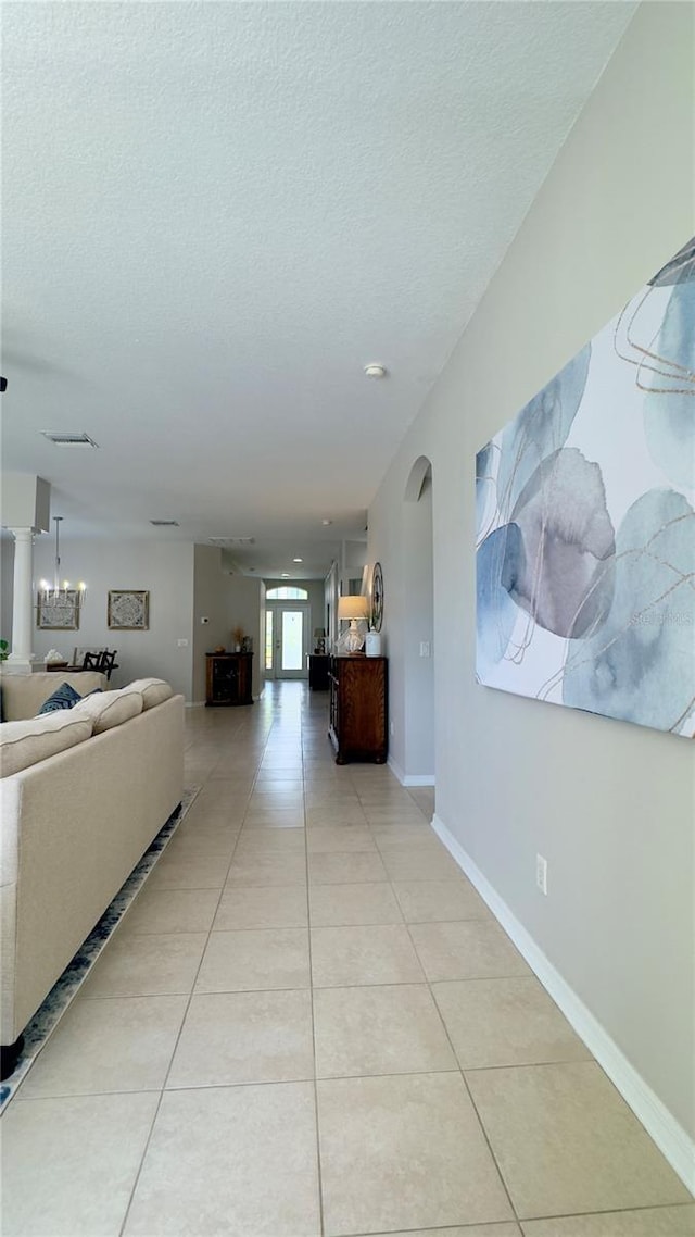 27312 Edenfield Dr, Wesley Chapel, FL 33544 - hall with arched walkways, a textured ceiling, and light tile patterned floors