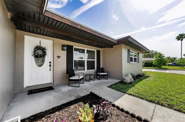 1800 Mapleleaf Blvd, Oldsmar, FL 34677 - entrance to property featuring a porch, stucco siding, and a lawn