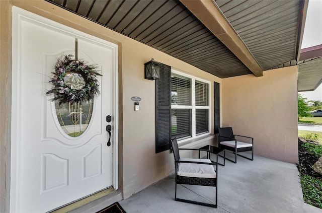 1800 Mapleleaf Blvd, Oldsmar, FL 34677 - doorway to property with a porch and stucco siding