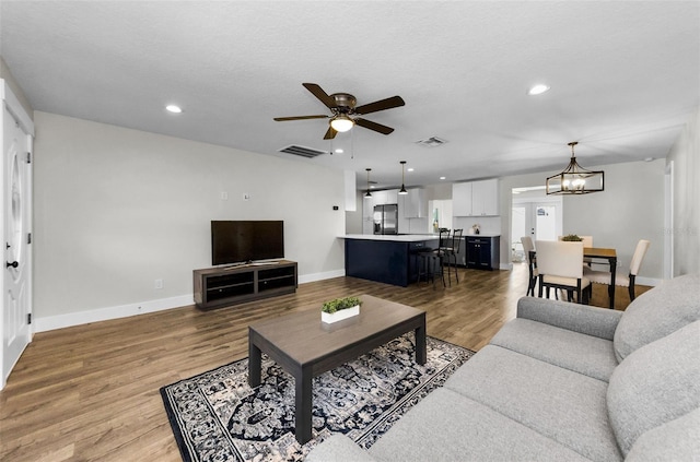 1800 Mapleleaf Blvd, Oldsmar, FL 34677 - living room featuring ceiling fan, a chandelier, light wood-style floors, and recessed lighting