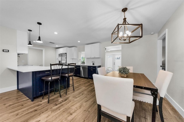 1800 Mapleleaf Blvd, Oldsmar, FL 34677 - dining room featuring light wood finished floors, a chandelier, and recessed lighting