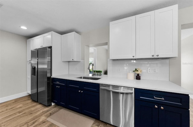 1800 Mapleleaf Blvd, Oldsmar, FL 34677 - kitchen with stainless steel appliances, blue cabinetry, light wood-style flooring, backsplash, and recessed lighting