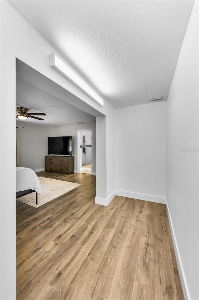1800 Mapleleaf Blvd, Oldsmar, FL 34677 - unfurnished living room featuring wood finished floors and a textured ceiling