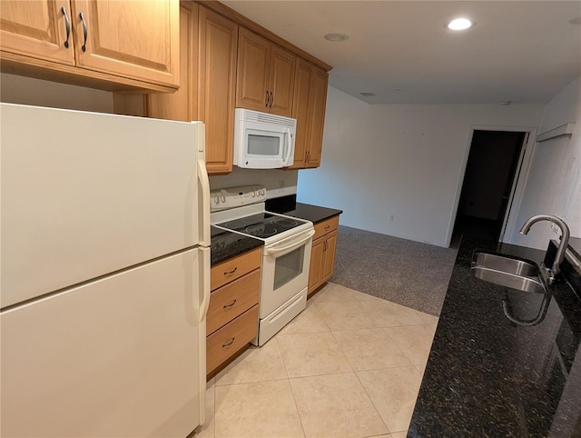 11308 Echo View Dr, Odessa, FL 33556 - kitchen with white appliances, recessed lighting, light colored carpet, light tile patterned floors, and dark stone countertops