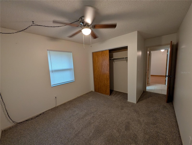 11308 Echo View Dr, Odessa, FL 33556 - unfurnished bedroom featuring carpet, a closet, a textured ceiling, and a ceiling fan