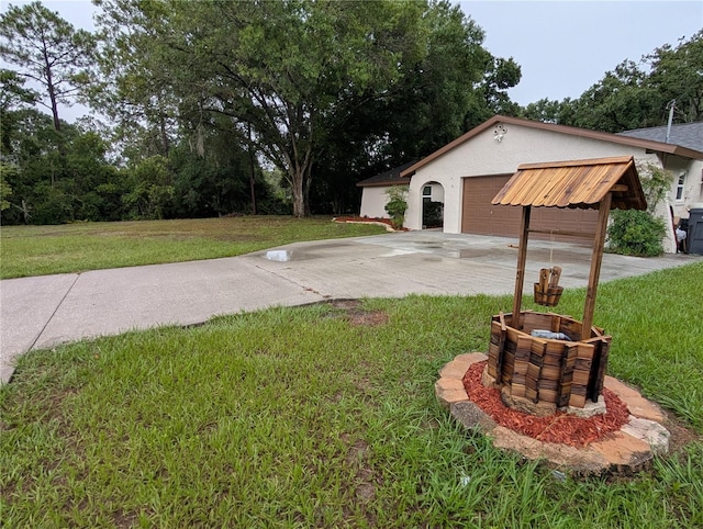 11308 Echo View Dr, Odessa, FL 33556 - view of green lawn with concrete driveway and a garage