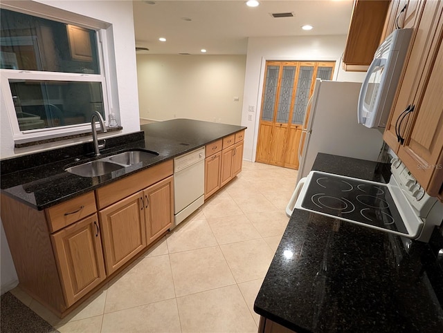 11308 Echo View Dr, Odessa, FL 33556 - kitchen with white appliances, recessed lighting, dark stone counters, and light tile patterned floors