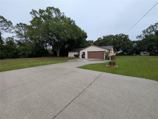 11308 Echo View Dr, Odessa, FL 33556 - view of front of home featuring concrete driveway, a front lawn, an attached garage, and view of scattered trees