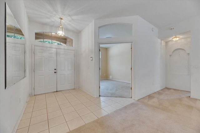 1216 Fox Chapel Dr, Lutz, FL 33549 - entrance foyer with light colored carpet, light tile patterned floors, and arched walkways