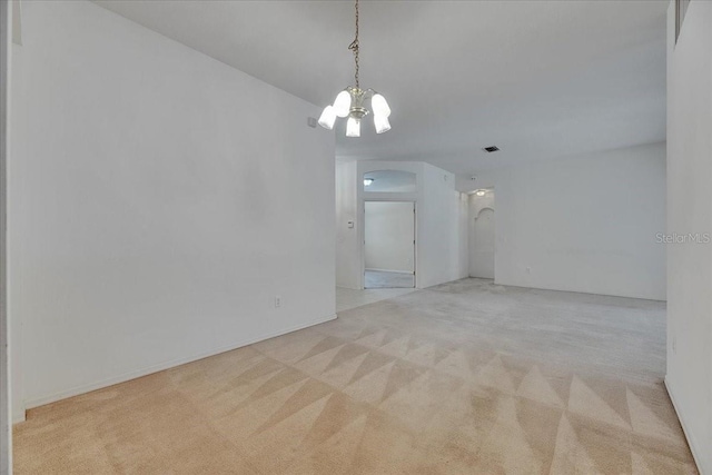 1216 Fox Chapel Dr, Lutz, FL 33549 - unfurnished room featuring arched walkways, carpet floors, and a chandelier