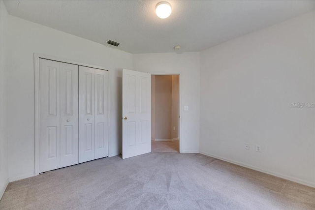 1216 Fox Chapel Dr, Lutz, FL 33549 - unfurnished bedroom featuring light carpet and a closet