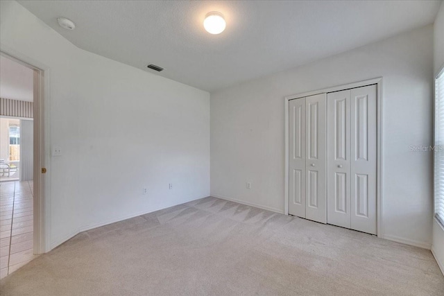 1216 Fox Chapel Dr, Lutz, FL 33549 - unfurnished bedroom with light colored carpet and a closet